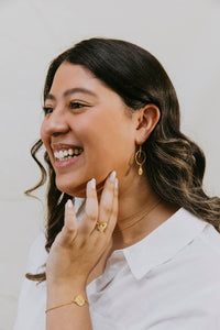 Delicate Sammy gold dangle hoop earrings with embellishments.