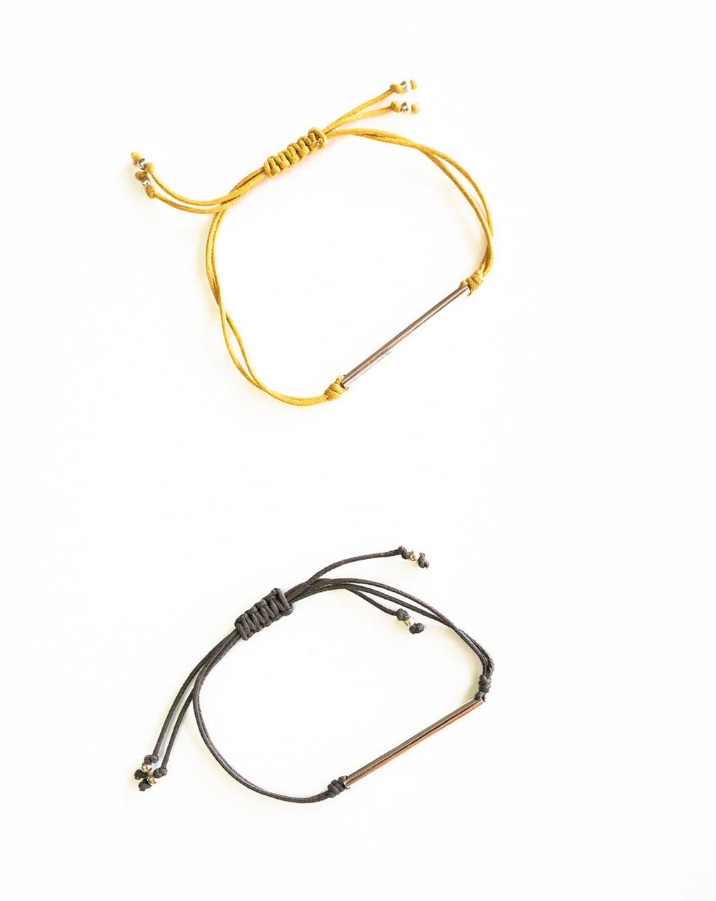 Kristine cord bracelets in silver and mustard with silver bars.