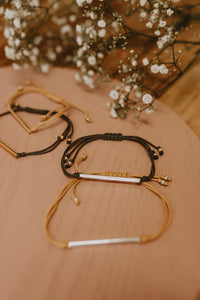 Kristine cord bracelets in slate and mustard with silver and gold bars.