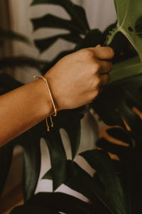 Kristine mustard cord bracelet with silver bar on model.