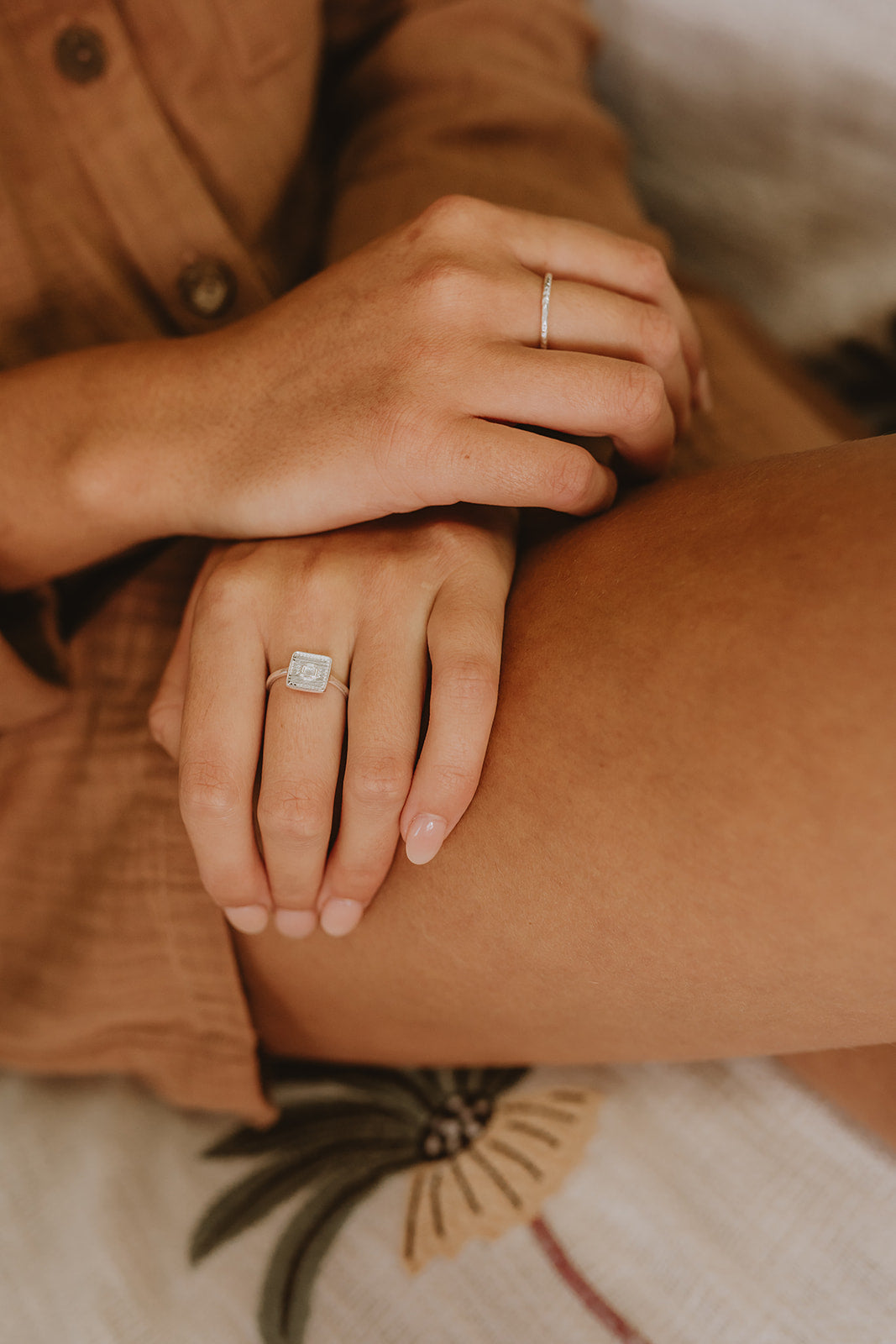 Delicate silver Suzy statement ring with square detail on model.